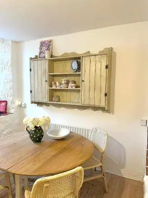 a dining room with a wooden table and chairs at Heart of St Ives with parking - 2 bedrooms in St Ives
