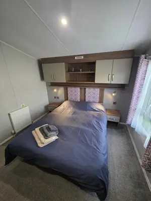 a bedroom with a large bed in a room at H05 Par Sands in Tywardreath