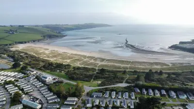 an aerial view of a beach with houses and the ocean at H05 Par Sands in Tywardreath