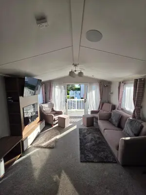 a living room with a couch and a tv at H05 Par Sands in Tywardreath