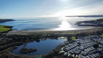 an aerial view of a lake and houses at H05 Par Sands in Tywardreath
