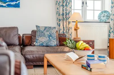 a living room with a couch and a table with a bowl of fruit at 3 Bed in Polperro oc-h34100 in Polperro