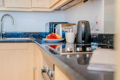 a kitchen counter with a sink and a plate of food at 3 Bed in Polperro oc-h34100 in Polperro