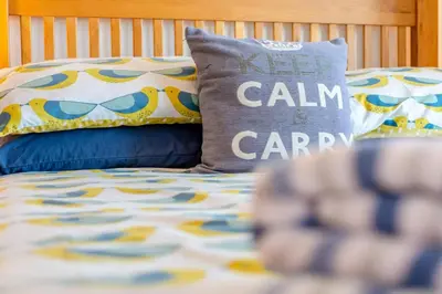 a bed with a pillow that says keep calm andaria at 3 Bed in Polperro oc-h34100 in Polperro