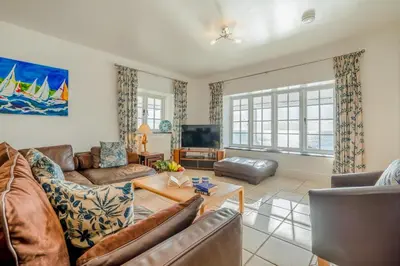 a living room with a couch and a table at 3 Bed in Polperro oc-h34100 in Polperro