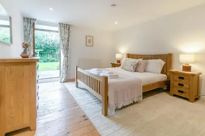 a bedroom with a bed and a window at 3 Bed in Torpoint oc-l32511 in Downderry