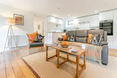 a living room with a couch and a table at 3 Bed in Torpoint oc-l32511 in Downderry