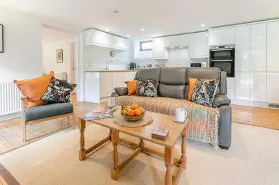 a living room with a couch and a table at 3 Bed in Torpoint oc-l32511 in Downderry