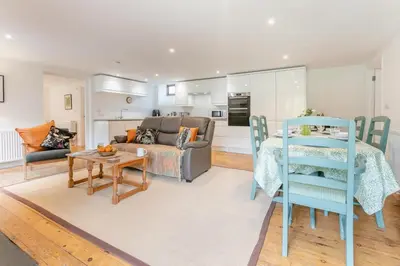 a living room with a couch and a table at 3 Bed in Torpoint oc-l32511 in Downderry