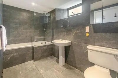 a bathroom with a toilet and a sink and a shower at 3 Bed in Torpoint oc-l32511 in Downderry
