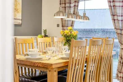 a wooden table with chairs and a dining room at 4 Bed in Winnards Perch oc-w34023 in Saint Columb Major