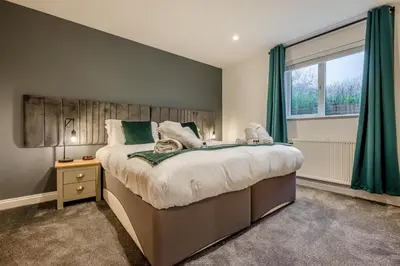 a bedroom with a large bed and a window at 4 Bed in Winnards Perch oc-w34023 in Saint Columb Major