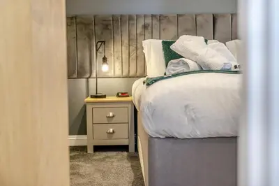 a small bedroom with a bed and a night stand at 4 Bed in Winnards Perch oc-w34023 in Saint Columb Major