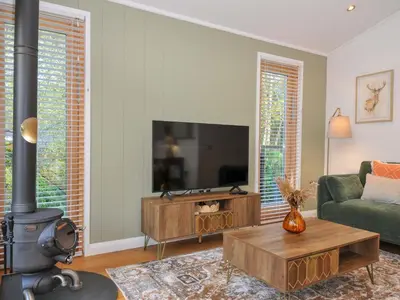 a living room with a couch and a fireplace at 6 Stonerush Valley in Looe