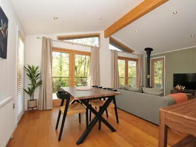 a living room with a table and a couch at 6 Stonerush Valley in Looe