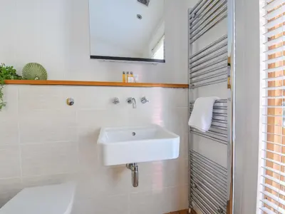 a bathroom with a sink and a toilet at 6 Stonerush Valley in Looe