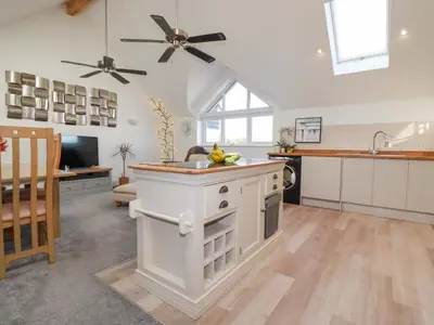 a kitchen with a island in the middle of a room at 33 Fordh Tobmen in St. Agnes