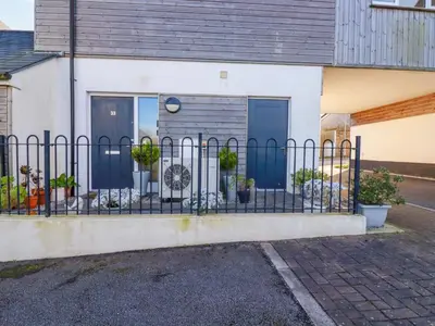 a fence in front of a house with plants at 33 Fordh Tobmen in St. Agnes