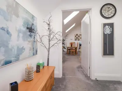 a hallway with a clock on the wall and a table at 33 Fordh Tobmen in St. Agnes