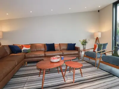a living room with a couch and a table at Harberton in Wadebridge
