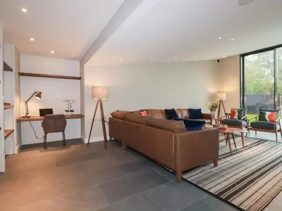 a living room with a couch and a table at Harberton in Wadebridge