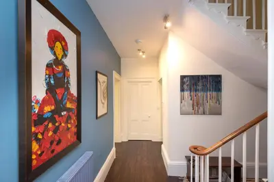 a hallway with a painting on the wall at The Old Vicarage in Wadebridge