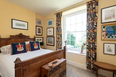 a bedroom with a wooden bed and a window at The Old Vicarage in Wadebridge