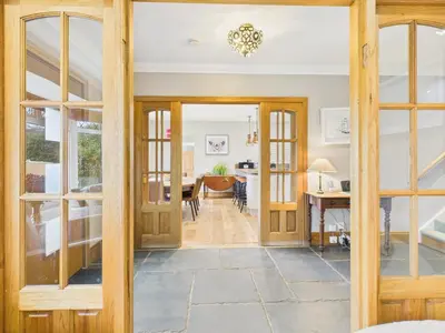 an open door into a dining room and living room at Wyvern – Beautiful & Spacious 4-Bedroom Home with Parking & Gardens in Falmouth