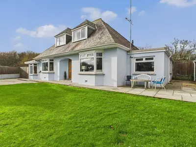 a house with a lawn in front of it at Wyvern – Beautiful & Spacious 4-Bedroom Home with Parking & Gardens in Falmouth