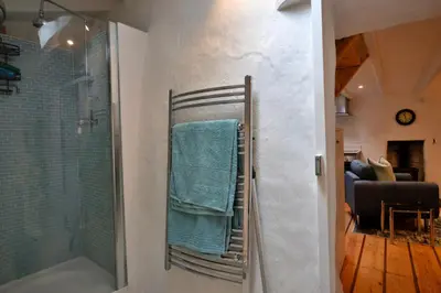 a bathroom with a shower and a towel rack at Finest Retreats - Spray Barn in Saint Ervan