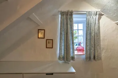 a room with a window with curtains at Finest Retreats - Spray Barn in Saint Ervan
