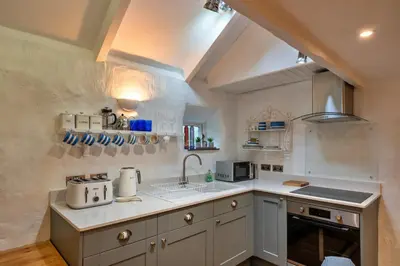 a kitchen with a sink and a counter top at Finest Retreats - Spray Barn in Saint Ervan