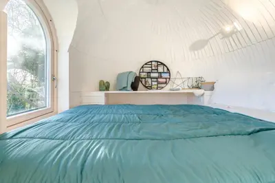 a bedroom with a blue bed in a white room at 1 Bed in Widegates oc-p34230 in Sheviock