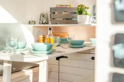 a kitchen counter with bowls and glasses on it at 1 Bed in Widegates oc-p34230 in Sheviock