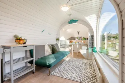 an arched room with a green couch and a table at 1 Bed in Widegates oc-p34230 in Sheviock