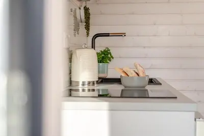 a kitchen counter with a sink with a bowl of bread at 1 Bed in Widegates oc-c34232 in Sheviock