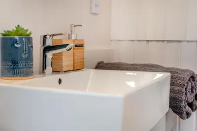 a white sink with a faucet in a bathroom at 1 Bed in Widegates oc-d34231 in Sheviock