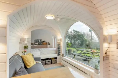 an arched room with a bed and a table at 1 Bed in Widegates oc-j34234 in Sheviock