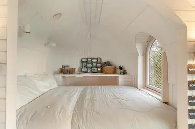 a white bedroom with a large bed with a window at 1 Bed in Widegates oc-j34234 in Sheviock