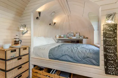a bedroom with a bed in a wooden room at 1 Bed in Widegates oc-p34233 in Sheviock