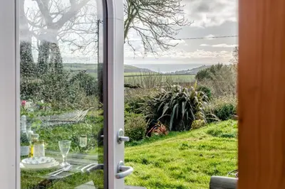 an open door with a view of a grassy field at 1 Bed in Widegates oc-p34233 in Sheviock