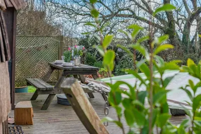 a wooden table and bench on a wooden deck at 1 Bed in Widegates oc-p34233 in Sheviock