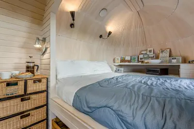 a bedroom with a bed and a wooden wall at 1 Bed in Widegates oc-p34233 in Sheviock