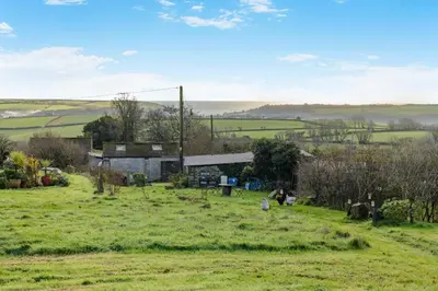 a field with a building in the distance at 1 Bed in Widegates oc-p34236 in Sheviock
