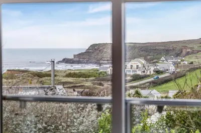 a view of the ocean from a window at 4 Bed in Widemouth Bay oc-s34119 in Widemouth Bay