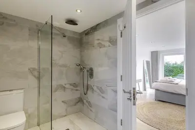 a bathroom with a shower with a glass door at 4 Bed in Widemouth Bay oc-s34119 in Widemouth Bay