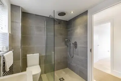a bathroom with a toilet and a glass shower at 4 Bed in Widemouth Bay oc-s34119 in Widemouth Bay