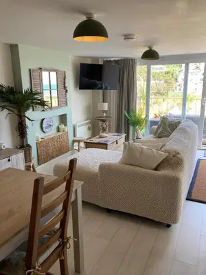 a living room with a couch and a table at Carrabee beachside haven for you & your pets in Saint Martin