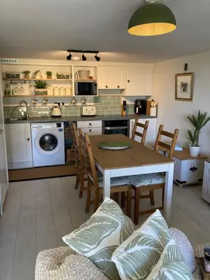 a kitchen with a table and chairs in a room at Carrabee beachside haven for you & your pets in Saint Martin