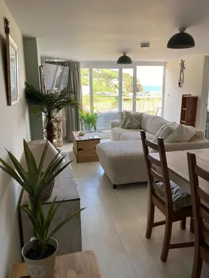 a living room with a couch and a table at Carrabee beachside haven for you & your pets in Saint Martin
